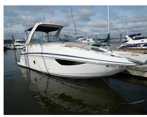 Regal 28 Express 2013 Regal 28 Express boat docked in marina, featuring sleek white design and modern amenities.
