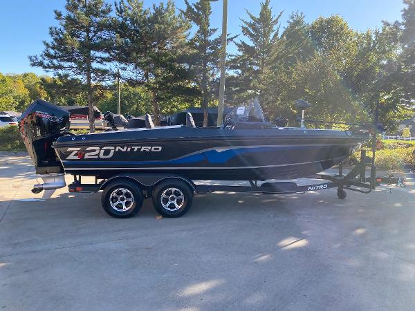Nitro ZV20 2024 Nitro ZV20 boat on trailer, parked outdoors with trees in background.