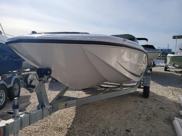 Bayliner M17 2024 Bayliner M17 boat on a trailer in a marina.