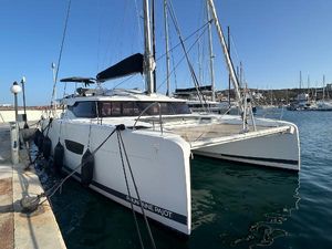 Fountaine Pajot Elba 45 2020 Fountaine Pajot Elba 45 catamaran docked in a marina under clear blue sky.