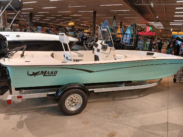 Mako Pro Skiff 17 CC 2025 Mako Pro Skiff 17 CC boat displayed indoors on a trailer.
