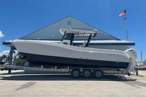 World Cat 325 CC 2026 World Cat 325 CC boat on trailer, parked outdoors under clear blue sky.
