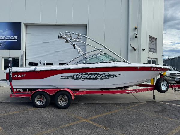 Moomba XLV 2006 Moomba XLV boat on red trailer parked outside a building.