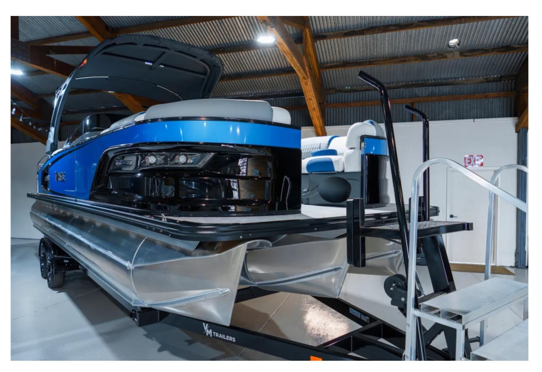 Tahoe Grand Tahoe LTD 2025 Tahoe Grand Tahoe LTD pontoon boat in showroom, featuring sleek blue design and modern seating.