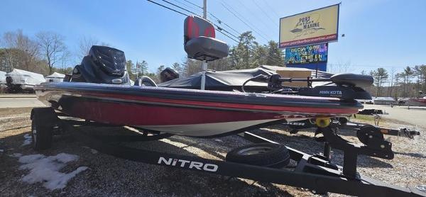 Nitro Z17 2025 Nitro Z17 boat on trailer, parked outdoors near dealership sign.