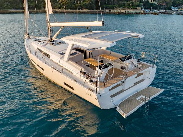 Hanse 460 2023 Hanse 460 sailboat on calm water, featuring dual steering wheels and spacious deck.