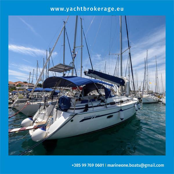 Bavaria Cruiser 39 2007 Bavaria Cruiser 39 yacht docked in marina, blue canopy, clear sky.