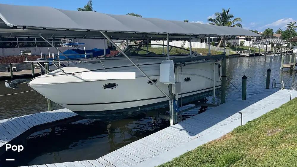 Rinker 280 Rinker 2007 Rinker 280 boat docked under a canopy on a sunny day.