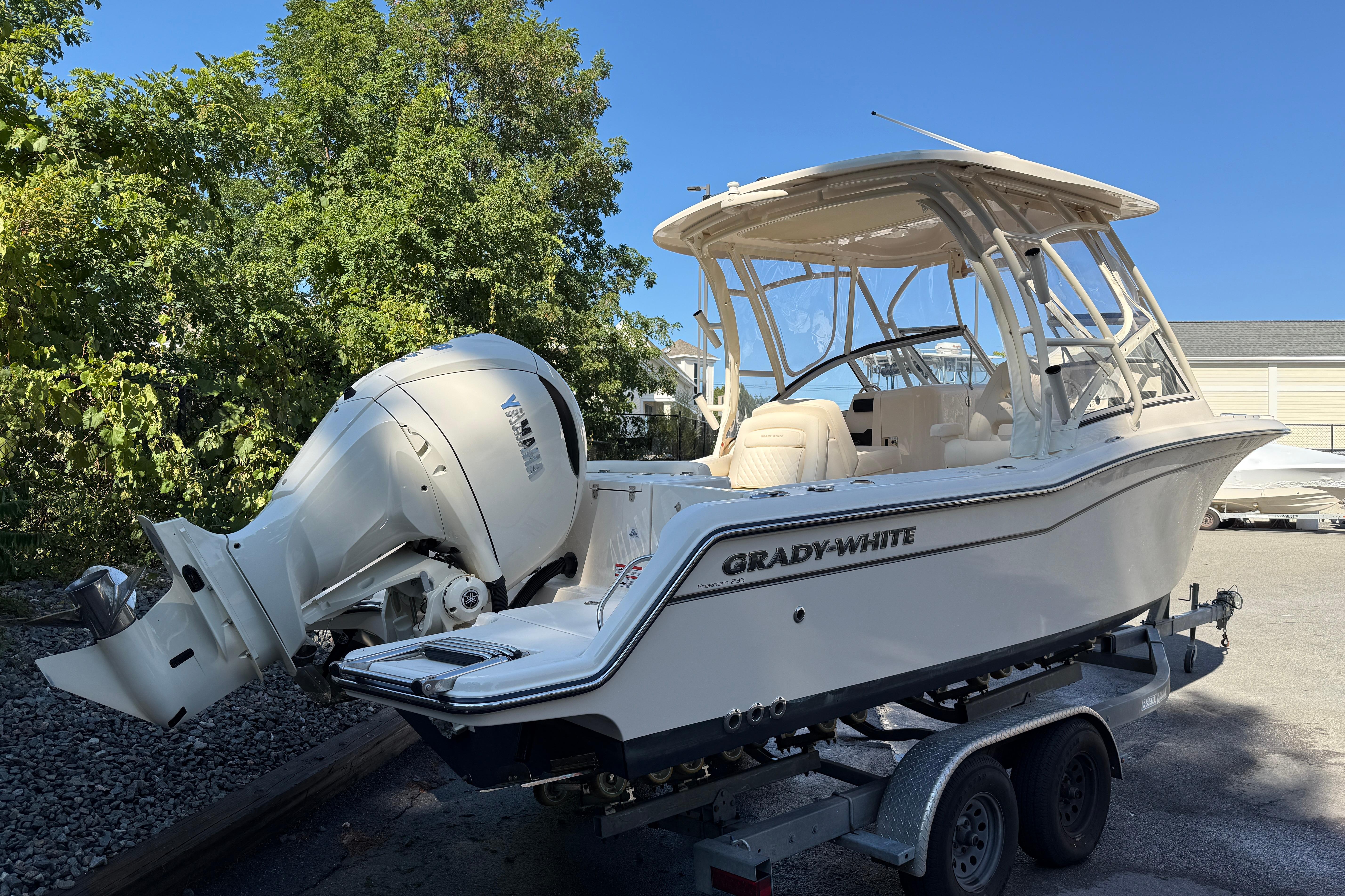 Grady-White Freedom 235 2026 Grady-White Freedom 235 boat on trailer, parked outdoors.