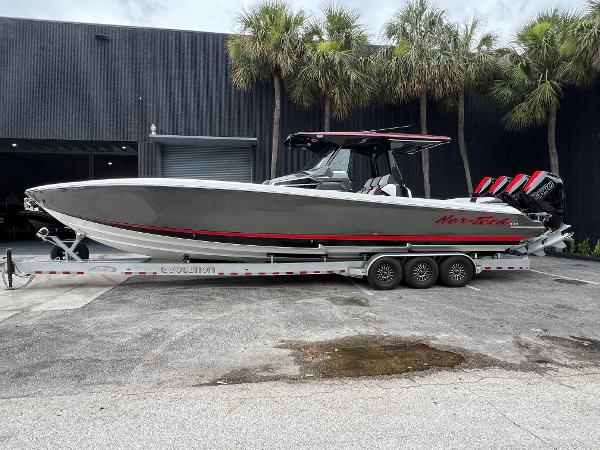 Nor-Tech 400 Supersport 2025 Nor-Tech 400 Supersport boat on trailer, parked outdoors near palm trees.