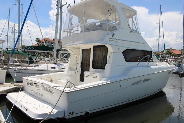Silverton 42 Convertible 2006 Silverton 42 Convertible yacht docked at marina, featuring spacious upper deck.
