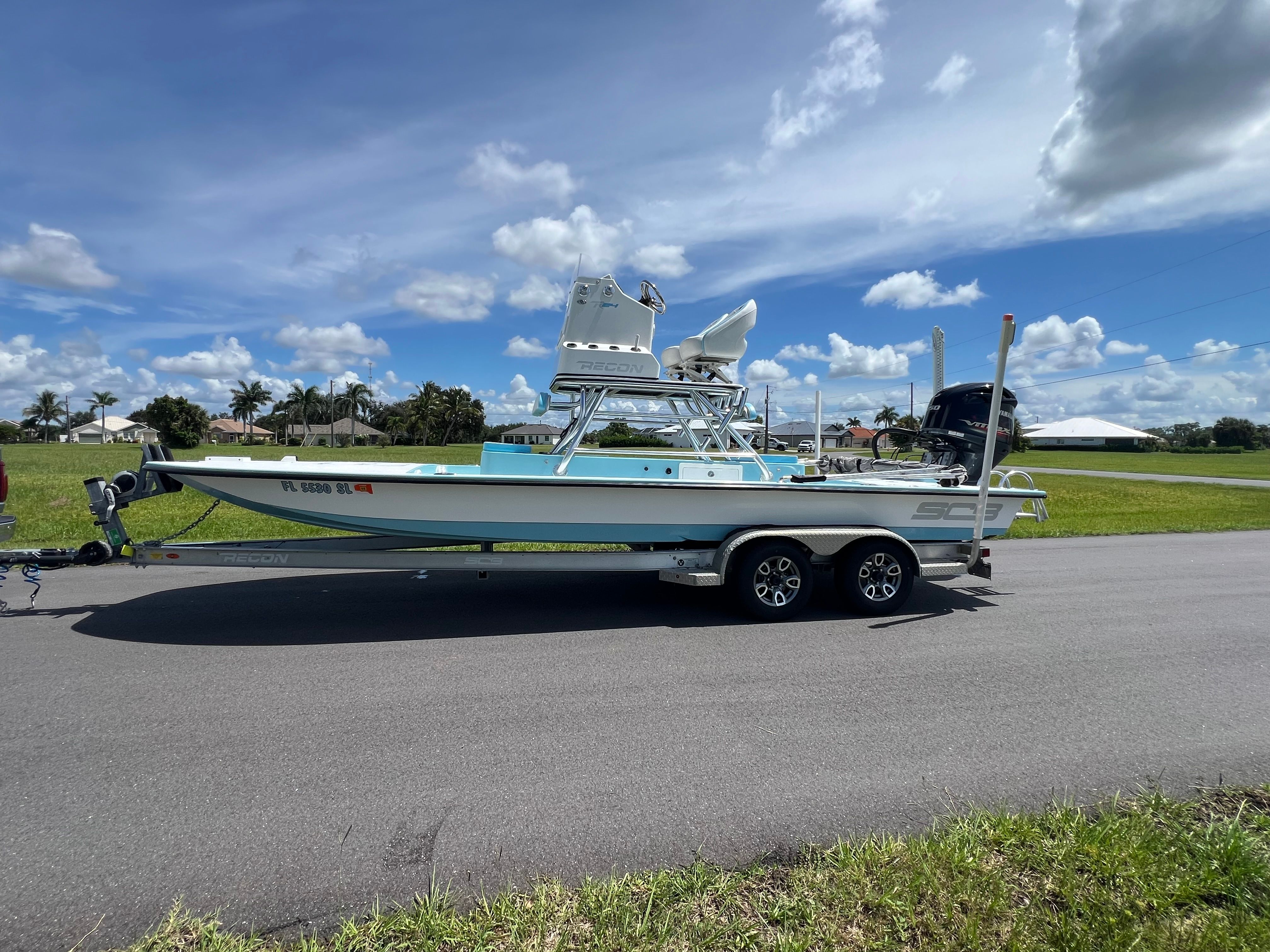 SCB Recon R24 2019 SCB Recon R24 boat on trailer under a clear blue sky.