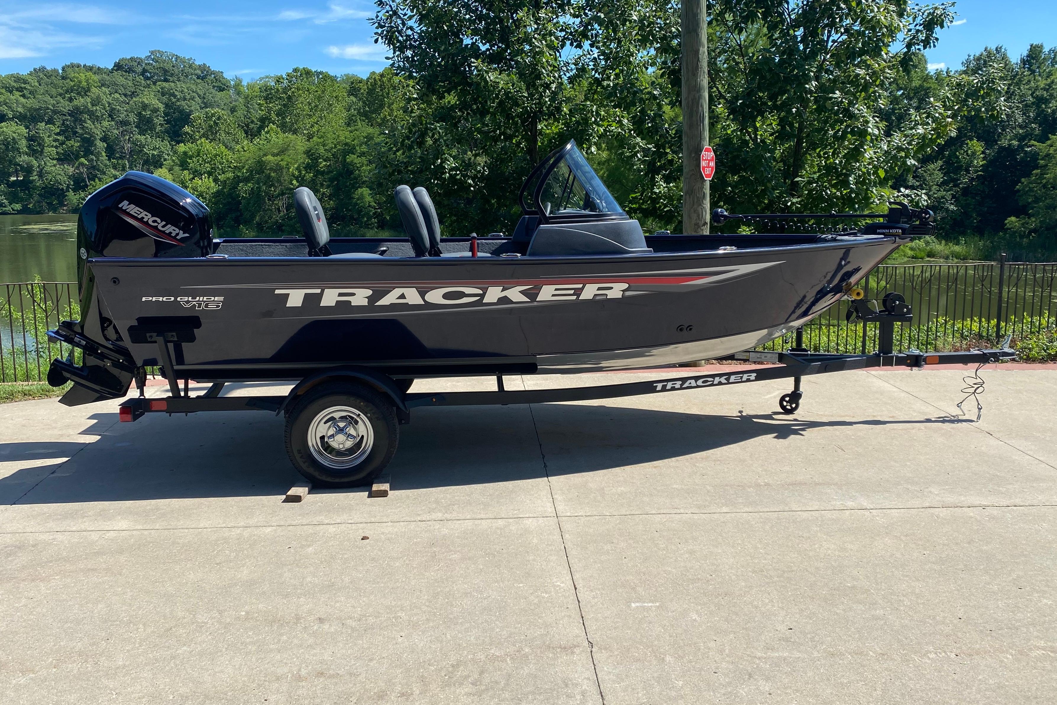 Tracker Pro Guide V-16 WT 2026 Tracker Pro Guide V-16 WT boat on trailer, parked near a scenic lake.