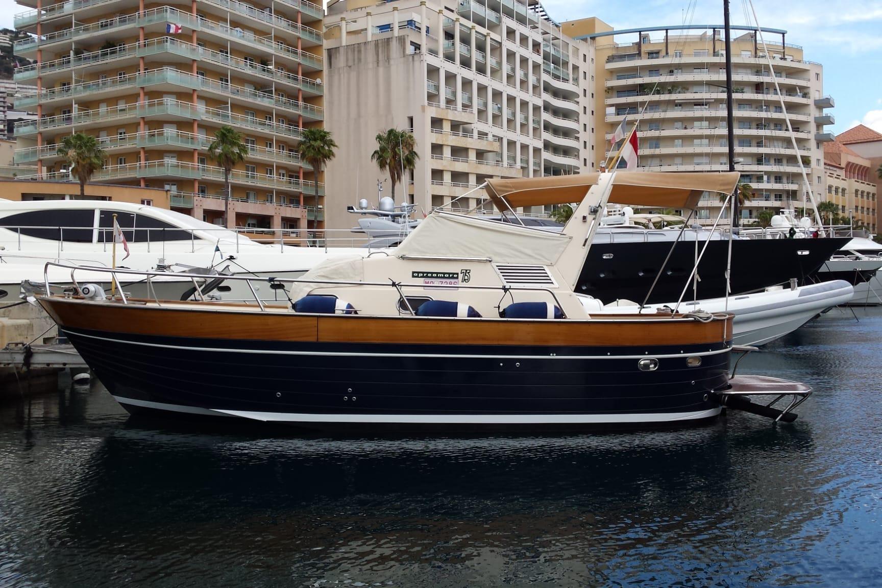 Apreamare 7.5m 1998 Apreamare 7.5m boat docked in a marina with modern buildings in the background.