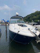 Sea Ray 270 Sundancer 2009 Sea Ray 270 Sundancer docked at marina, clear sky, lush greenery in background.