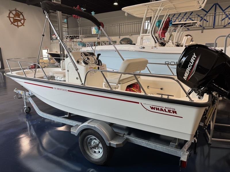 Boston Whaler 150 Montauk 2025 Boston Whaler 150 Montauk boat on trailer in showroom.