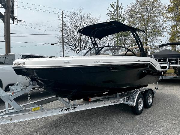 Bayliner DX2000 2024 Bayliner DX2000 boat on a trailer, black hull, white trim, and canopy.