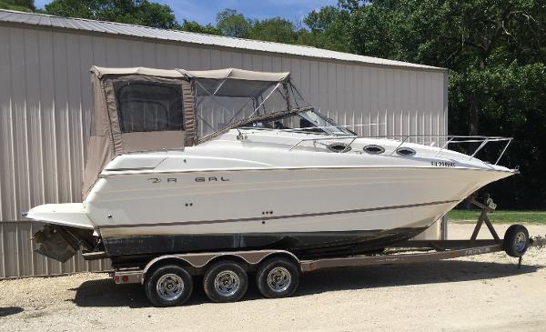 Regal 2765 Regal 2003 Regal 2765 boat on trailer, parked beside a metal building.