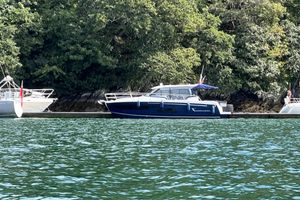 Jeanneau Merry Fisher 1095 Coupe 2020 Jeanneau Merry Fisher 1095 Coupe docked by lush green trees.