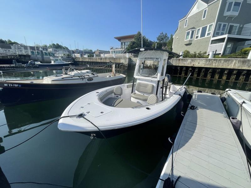 Sportsman 212 open 2023 Sportsman 212 Open boat docked in a marina, surrounded by other vessels.