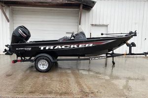Tracker Super Guide V-16 SC 2026 Tracker Super Guide V-16 SC fishing boat on trailer, black exterior, parked outdoors.