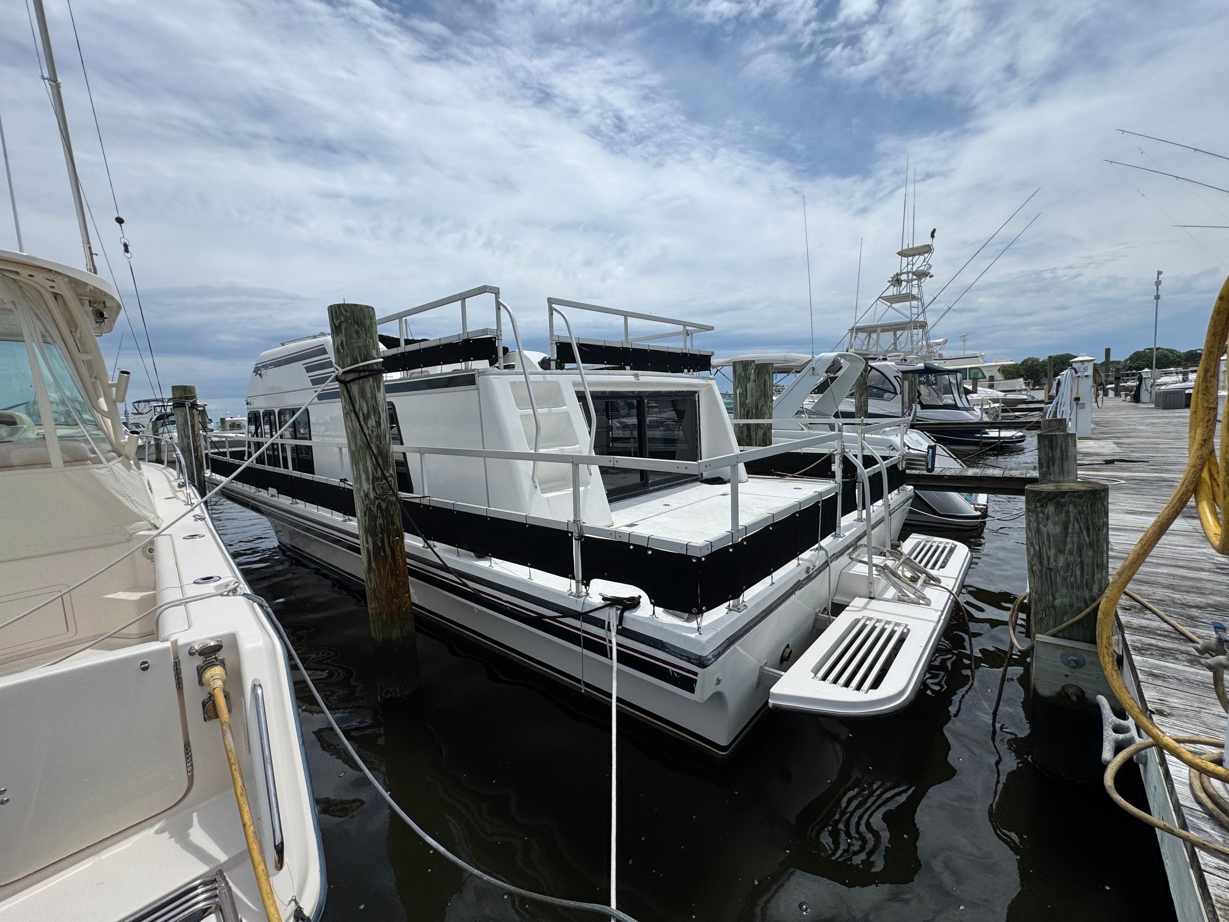 Gibson 37 Sport Series 1993 Gibson 37 Sport Series boat docked at a marina under a cloudy sky.
