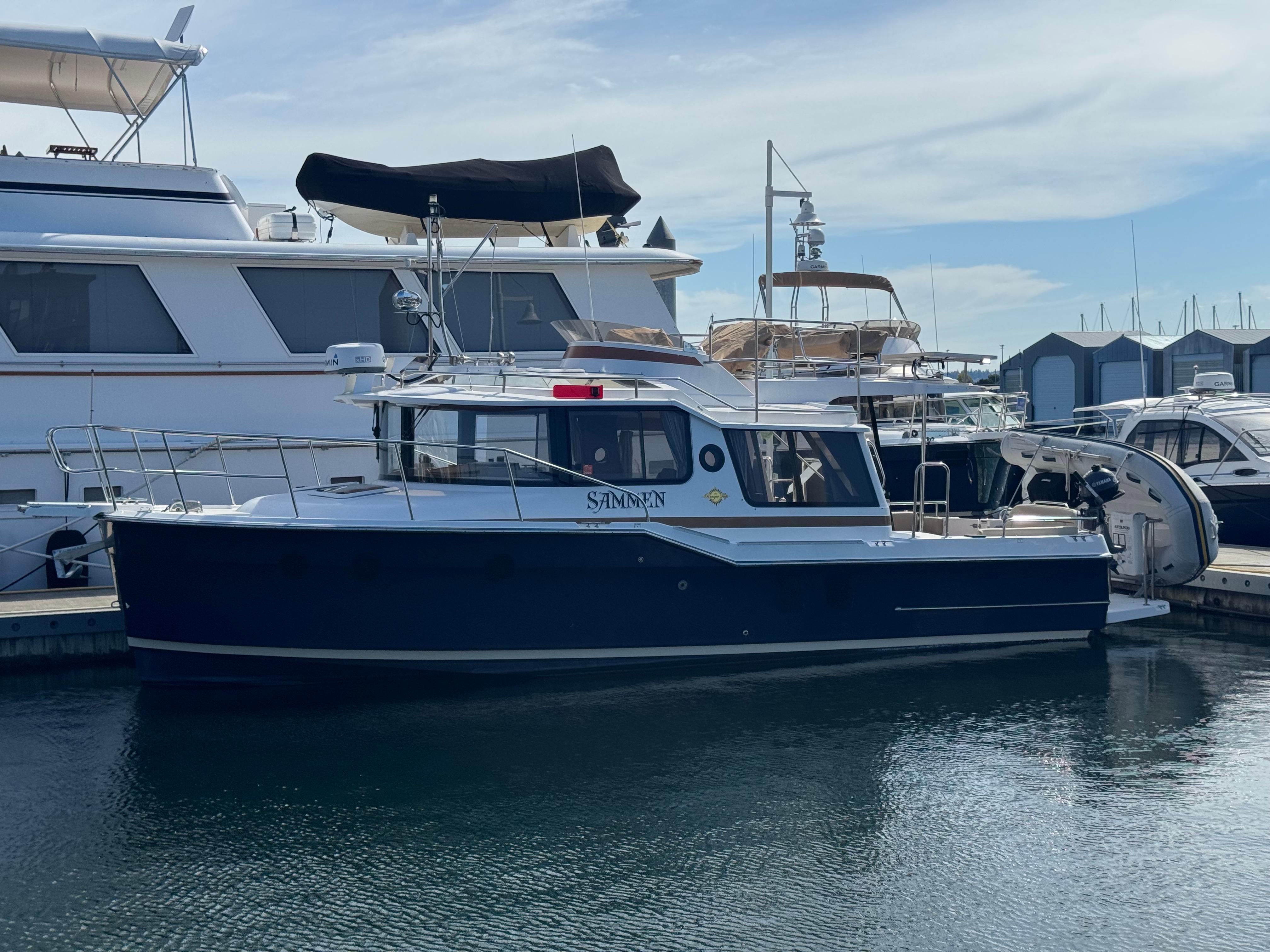 Ranger Tugs R-29 CB 2019 Ranger Tugs R-29 CB boat docked at marina, side view.
