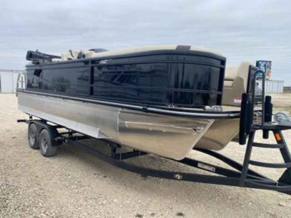 SunCatcher Select 322RC 2025 SunCatcher Select 322RC pontoon boat on trailer, parked on gravel.