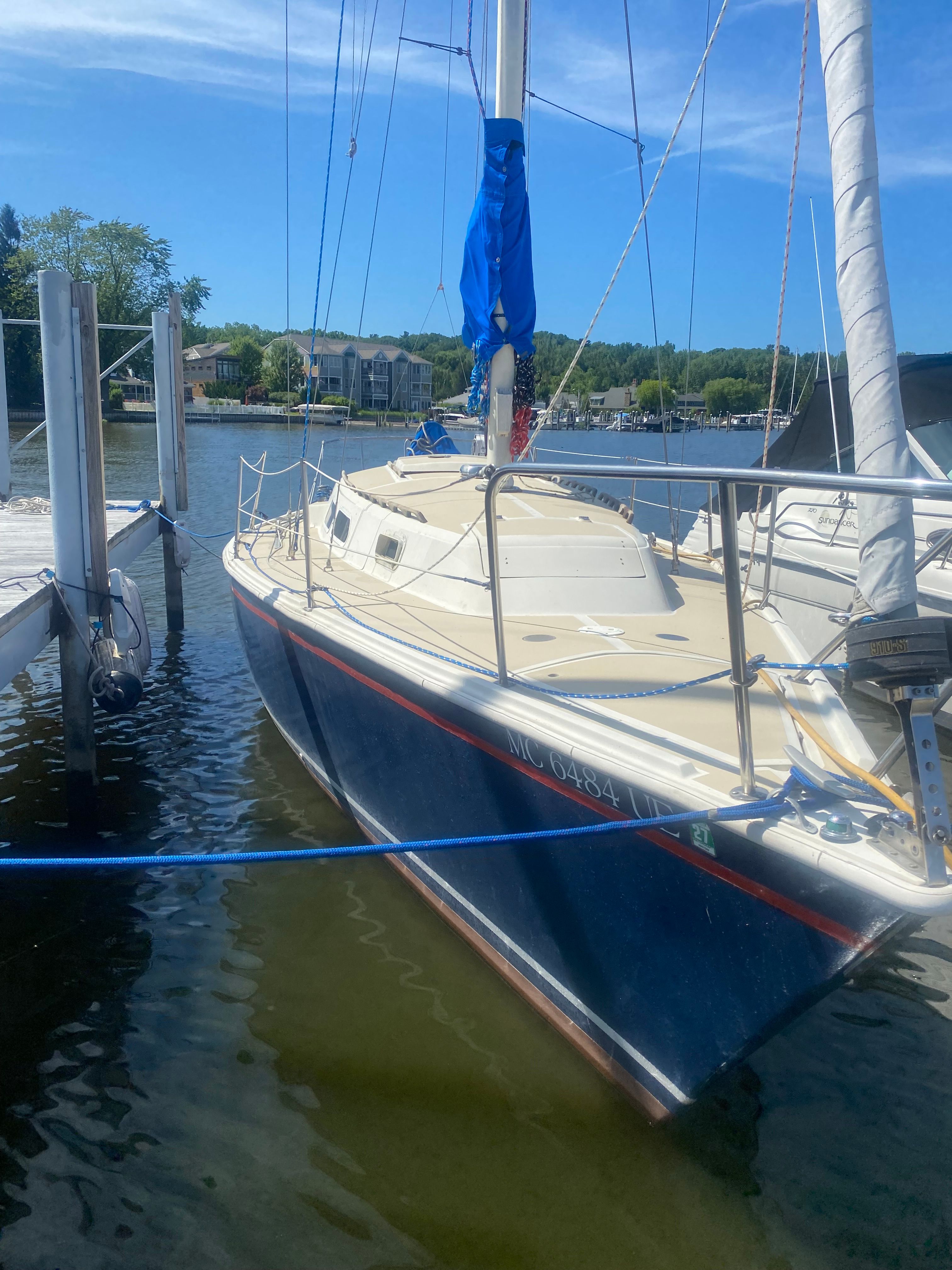 O'Day 30 1980 O'Day 30 sailboat docked in a marina under a clear blue sky.