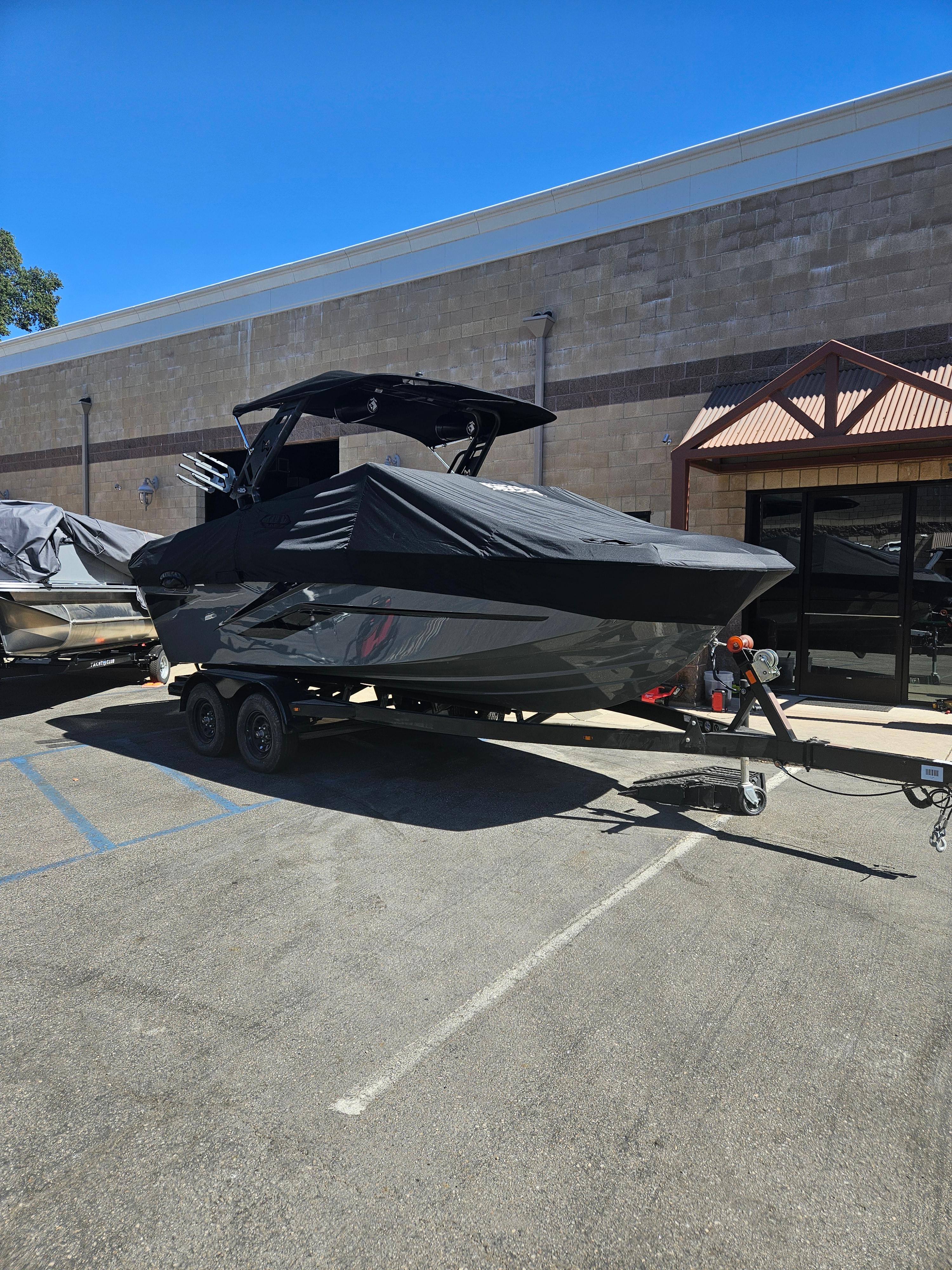 HEYDAY WAKE BOATS H20 2024 HEYDAY WAKE BOATS H20 covered on trailer in parking lot.