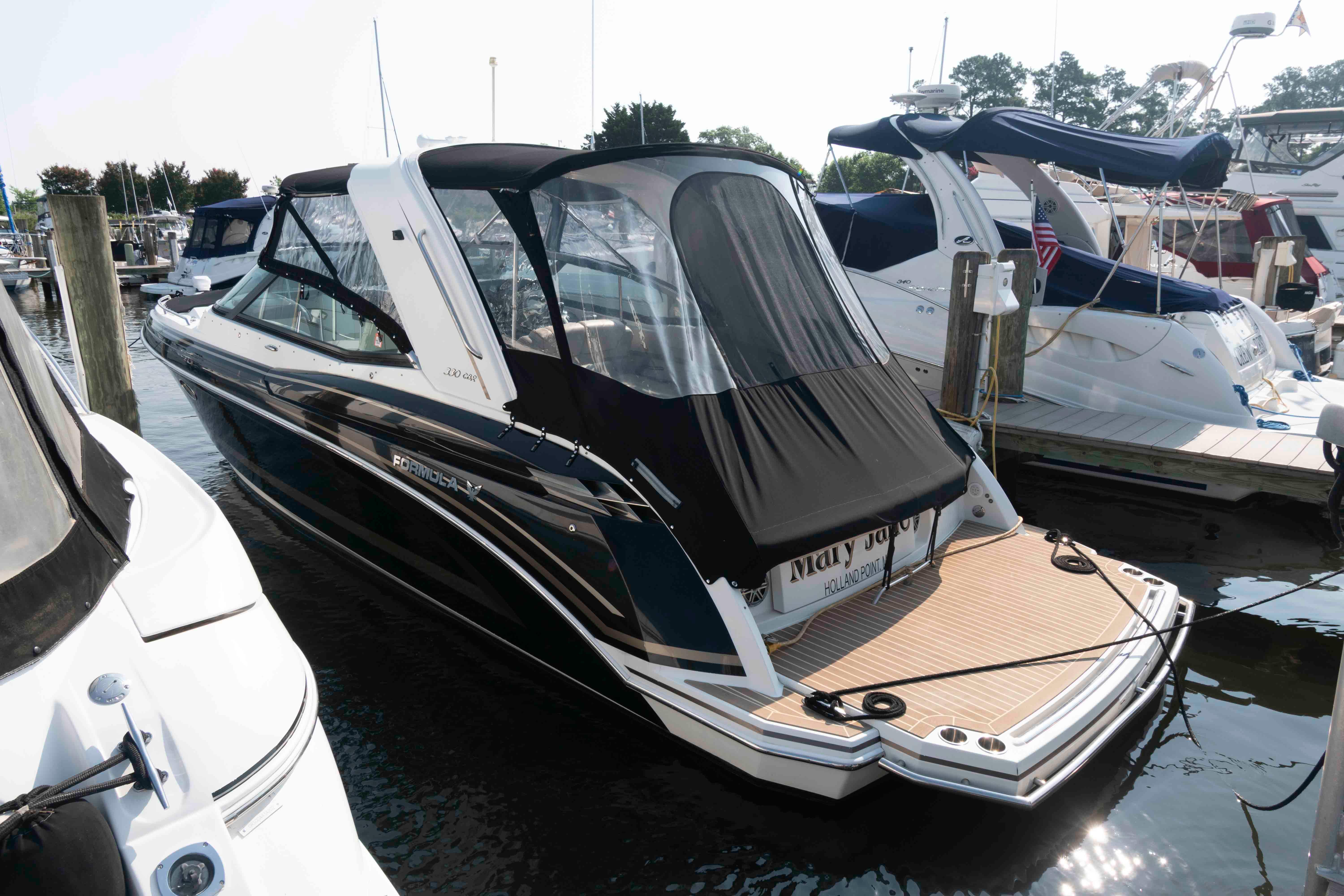 Formula 330 Crossover Bowrider 2016 Formula 330 Crossover Bowrider docked at marina, featuring sleek design and black canopy.