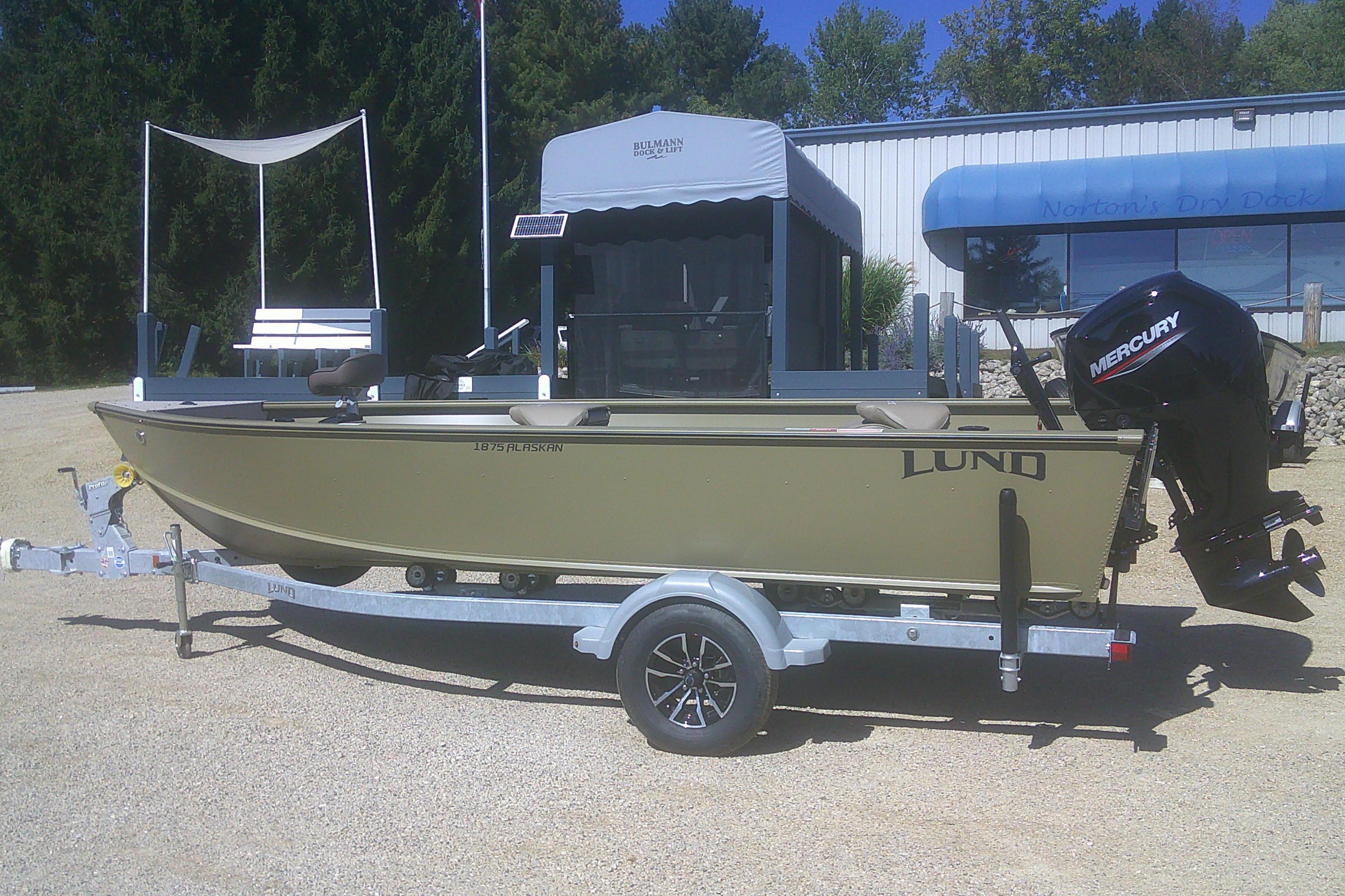 Lund 1875 Alaskan Tiller 2026 Lund 1875 Alaskan Tiller boat on trailer with Mercury outboard motor.