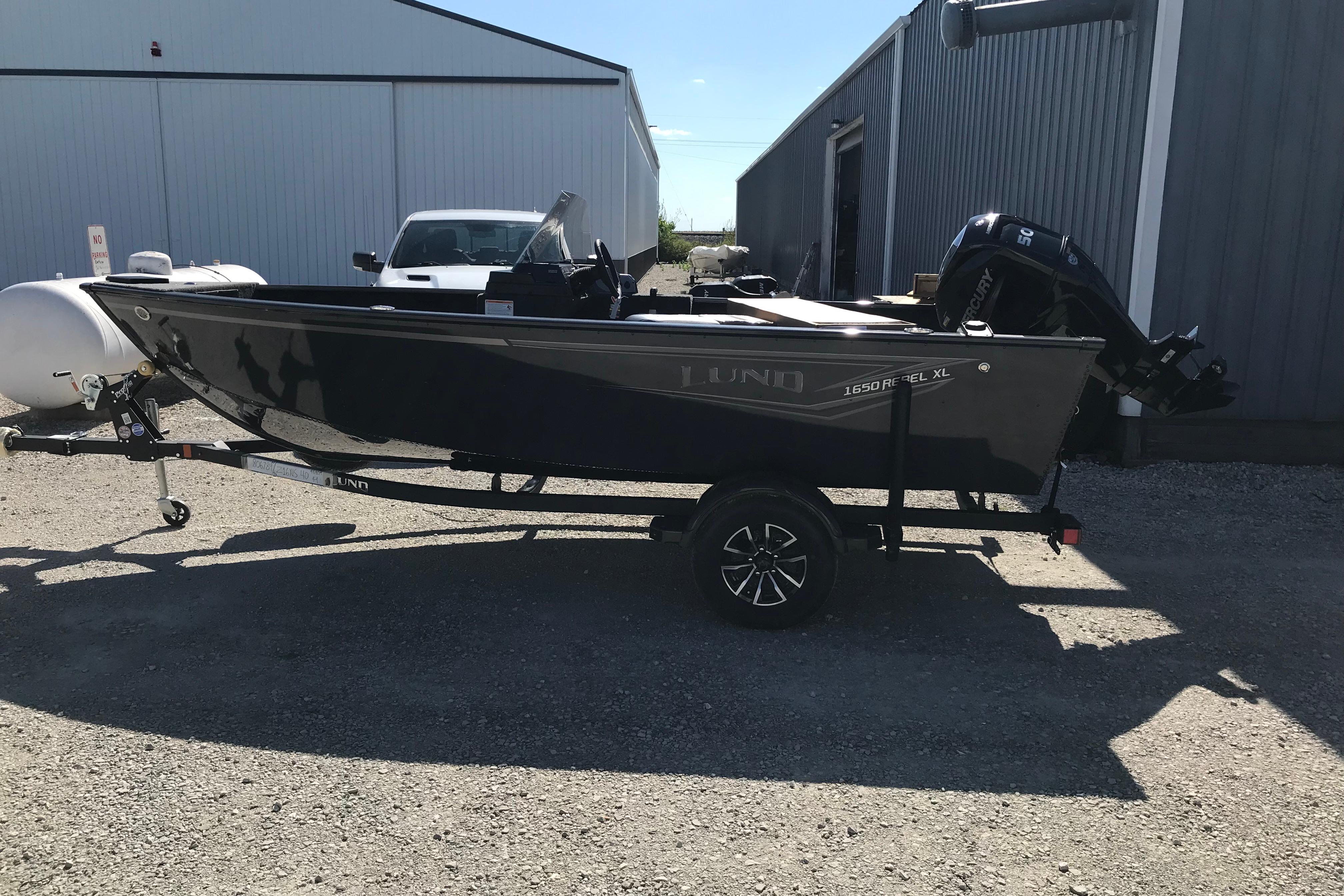 Lund 1650 Rebel XL SS 2026 Lund 1650 Rebel XL SS boat on trailer, parked outdoors.