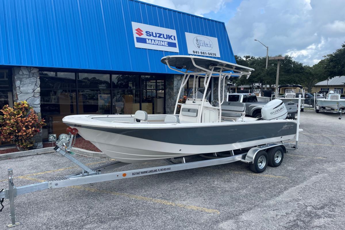 Carolina Skiff 24 Ultra Elite 2025 Carolina Skiff 24 Ultra Elite boat on trailer outside Suzuki Marine dealership.