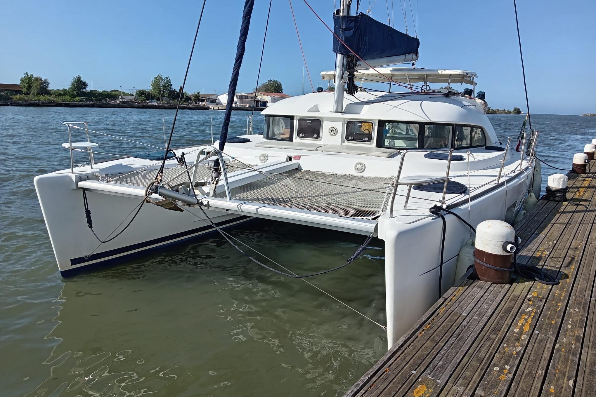 Lagoon 380 S2 2007 Lagoon 380 S2 catamaran docked at a wooden pier on a sunny day.