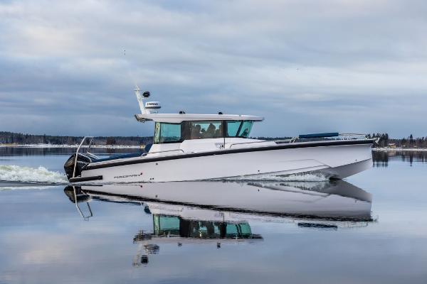 Axopar 29 XC Cross Cabin 2025 Axopar 29 XC Cross Cabin boat cruising on calm water.