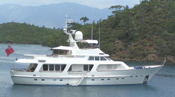 Moonen 85 Luxury 1989 Moonen 85 yacht anchored in scenic bay with lush greenery.