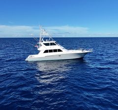 Viking Enclosed Bridge 1997 Viking Enclosed Bridge yacht on open ocean under clear blue sky.
