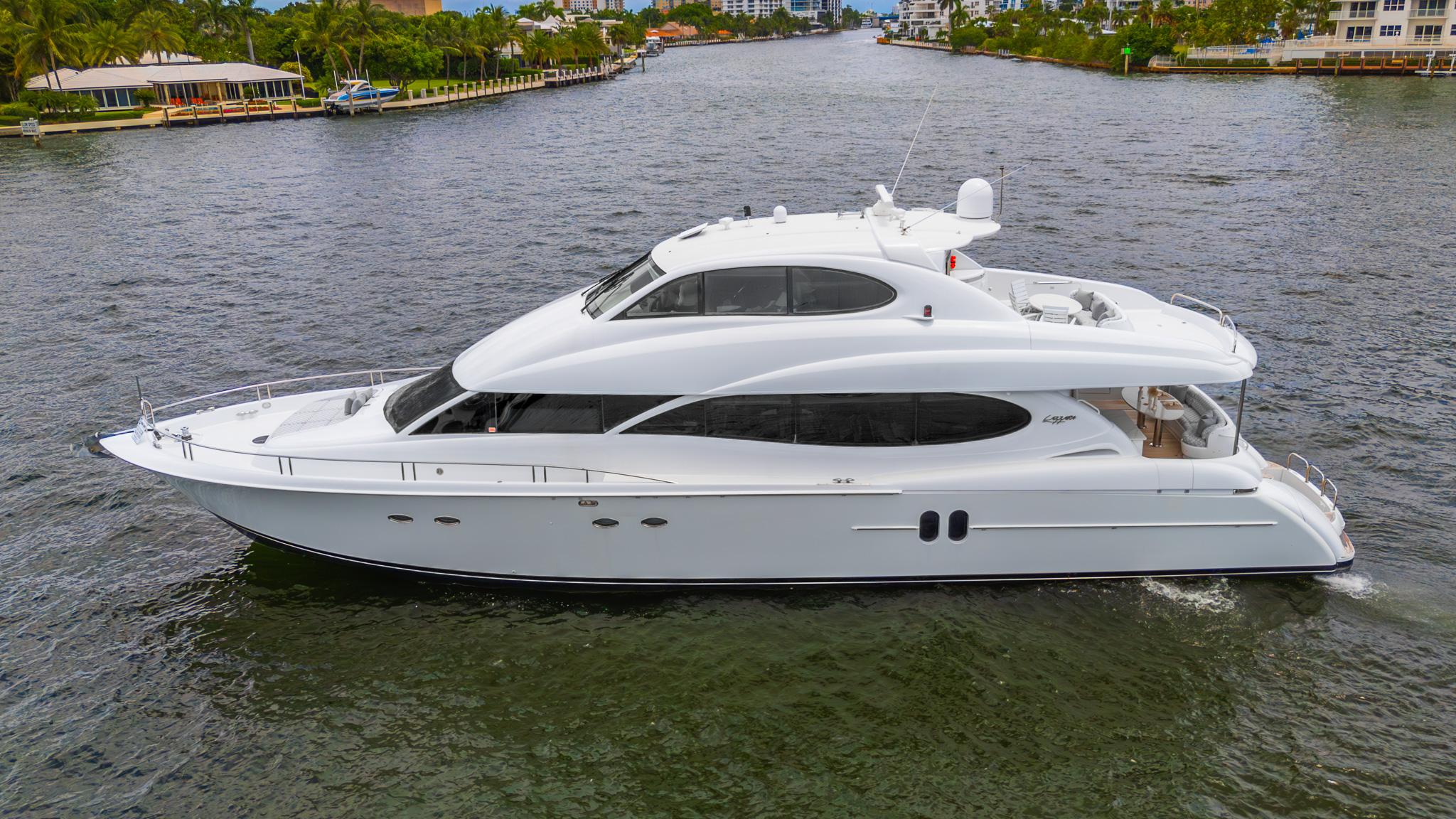 Lazzara 80 Skylounge 2002 Lazzara 80 Skylounge yacht cruising on a scenic waterway.