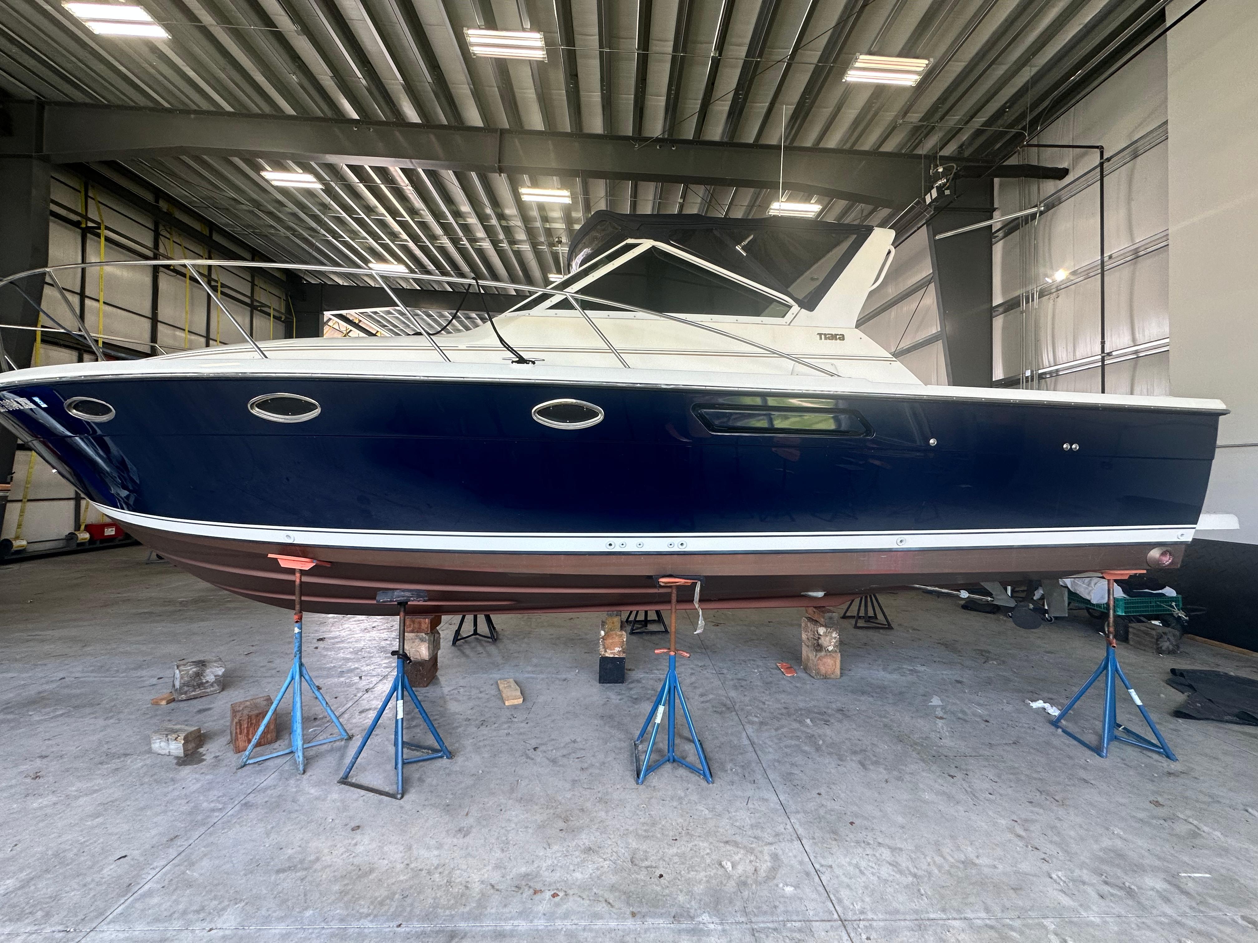 Tiara Yachts 3100 Open 1997 Tiara Yachts 3100 Open in a boatyard, elevated on stands for maintenance.