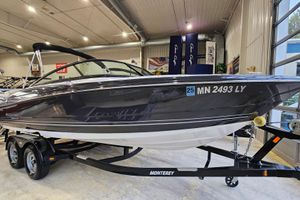 Monterey 224FS 2020 Monterey 224FS boat on trailer in indoor showroom setting.