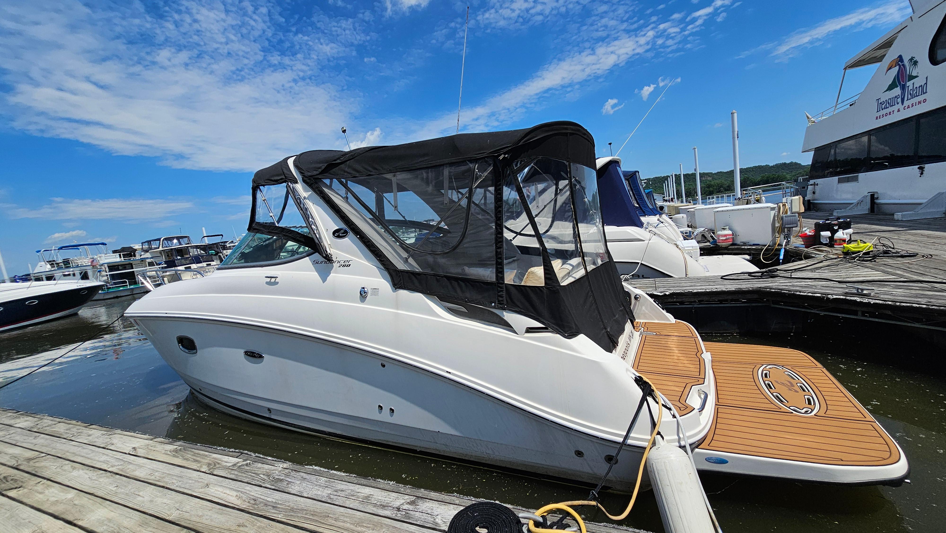 Sea Ray 280 Sundancer 2013 Sea Ray 280 Sundancer docked at marina under clear blue sky.