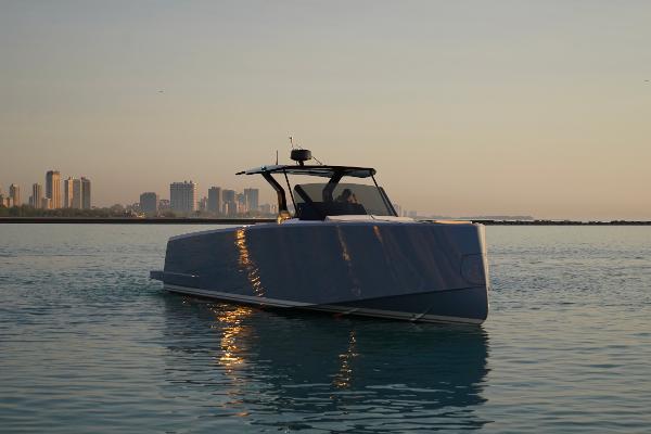 Pardo Yachts P43 2025 Pardo Yachts P43 cruising near city skyline at sunset.