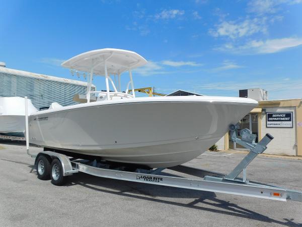 Aquasport 2200 Center Console 2024 Aquasport 2200 Center Console boat on a trailer in a marina.