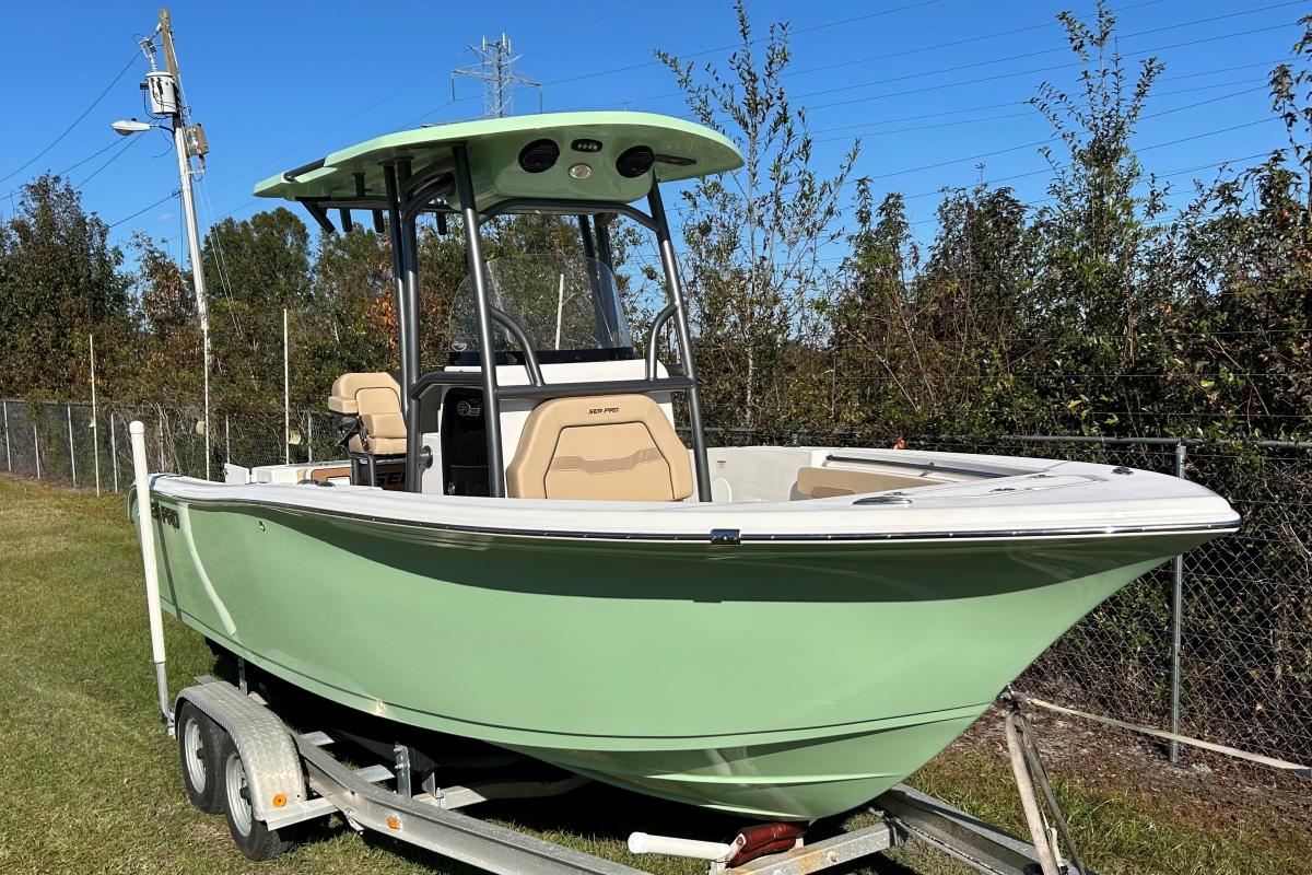 Sea Pro 222 CC 2025 Sea Pro 222 CC boat on trailer, light green hull, parked on grass.