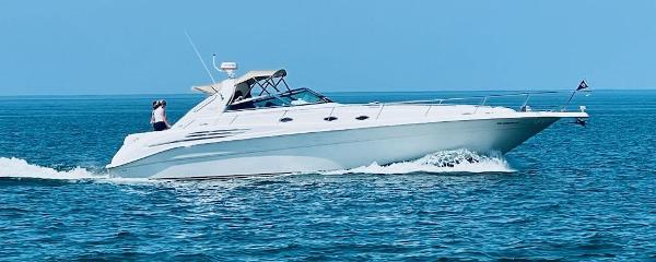 Sea Ray 450 Sundancer 1995 Sea Ray 450 Sundancer cruising on open water under clear blue skies.