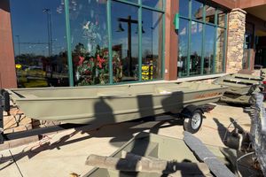 Tracker Grizzly 15 Jon 2026 Tracker Grizzly 15 Jon boat displayed outside a store with holiday decorations.