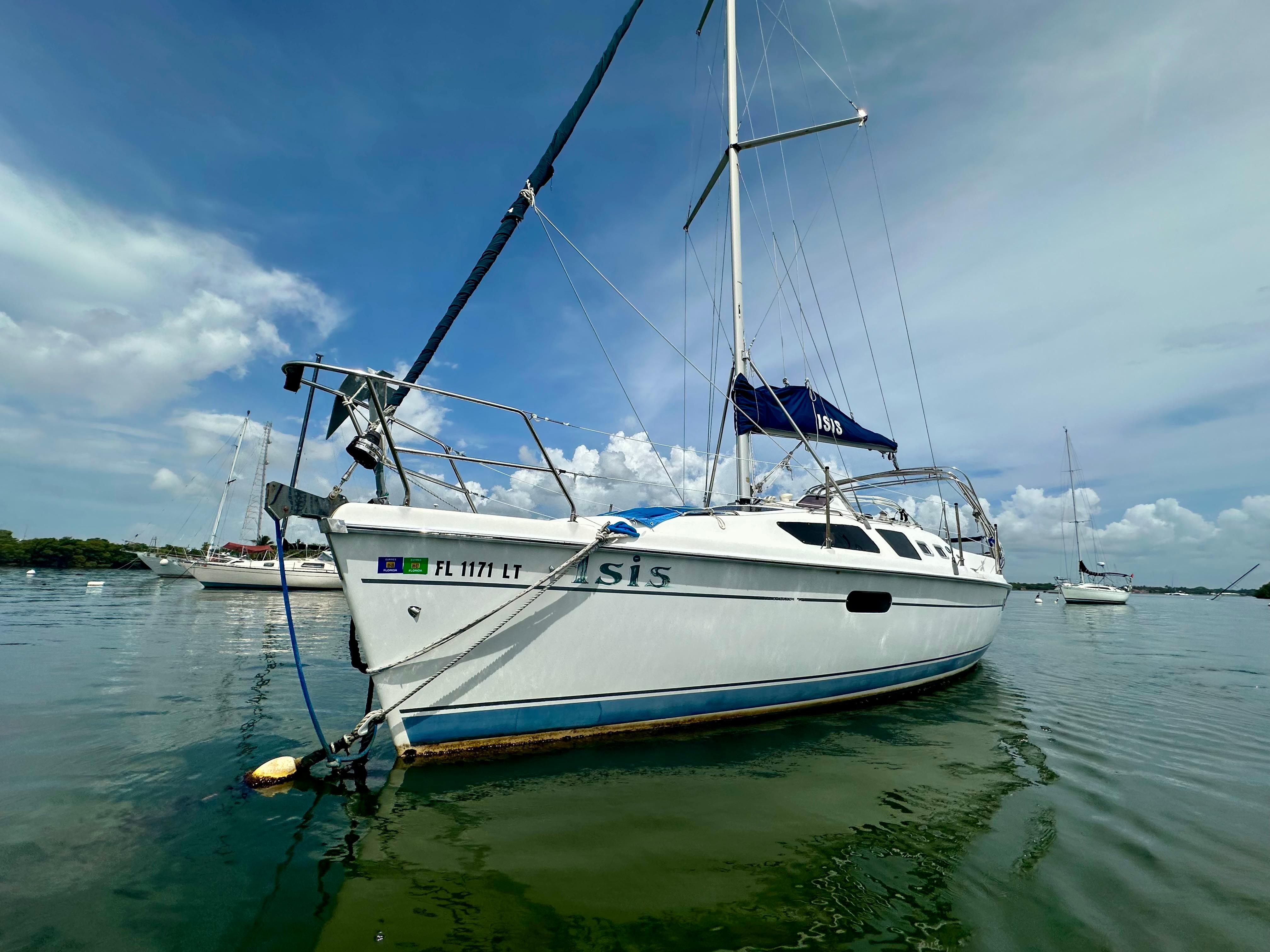 Hunter 326 Sailboat Hunter 326, 2002 model, anchored on calm water under a clear blue sky.