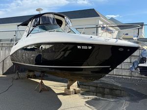 Sea Ray 280 Sundancer 2014 Sea Ray 280 Sundancer boat on stands, black and white exterior, sunny day.