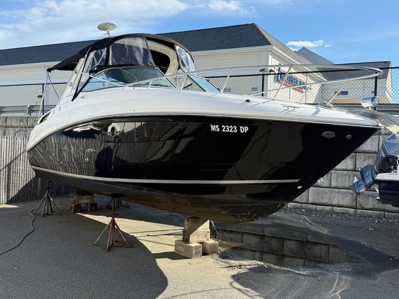 Sea Ray 280 Sundancer 2014 Sea Ray 280 Sundancer boat on stands, black and white exterior, sunny day.